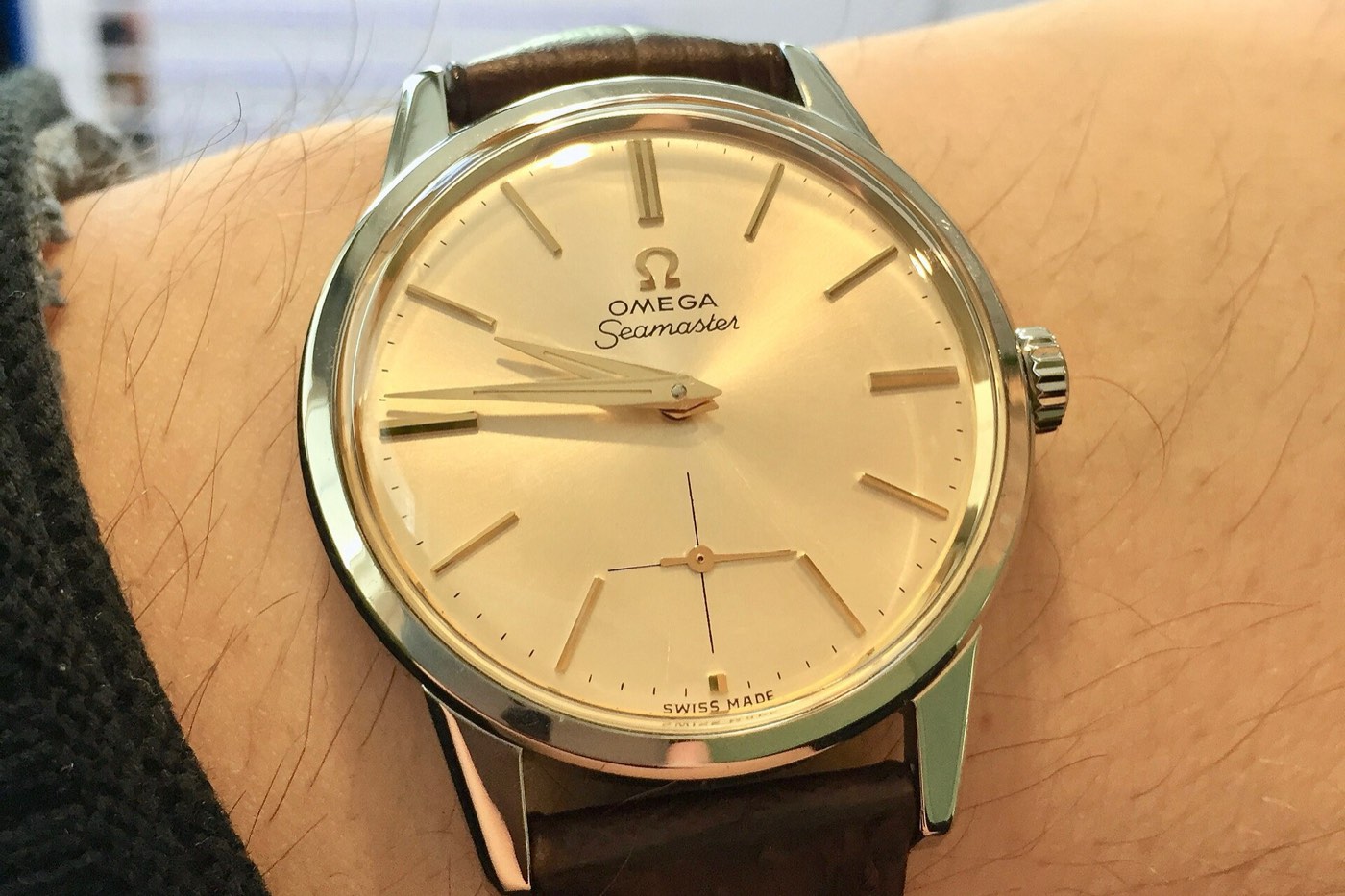 Omega Seamaster from around 1960 on the wrist, with a champagne dial and small seconds
