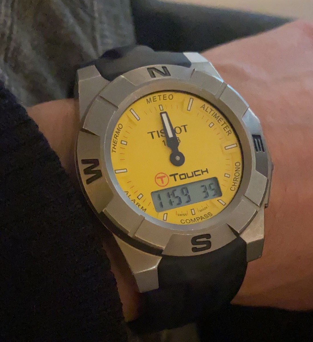 Yellow-dial Tissot T-Touch on a wrist, with compass and altimeter markings